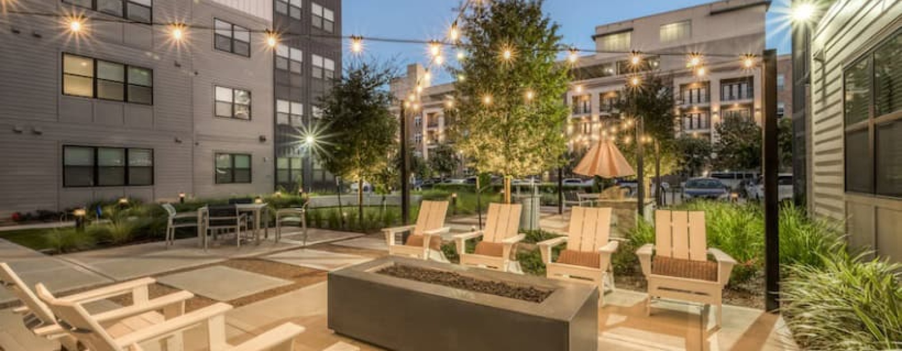 night time view of the apartment community firepit and courtyard