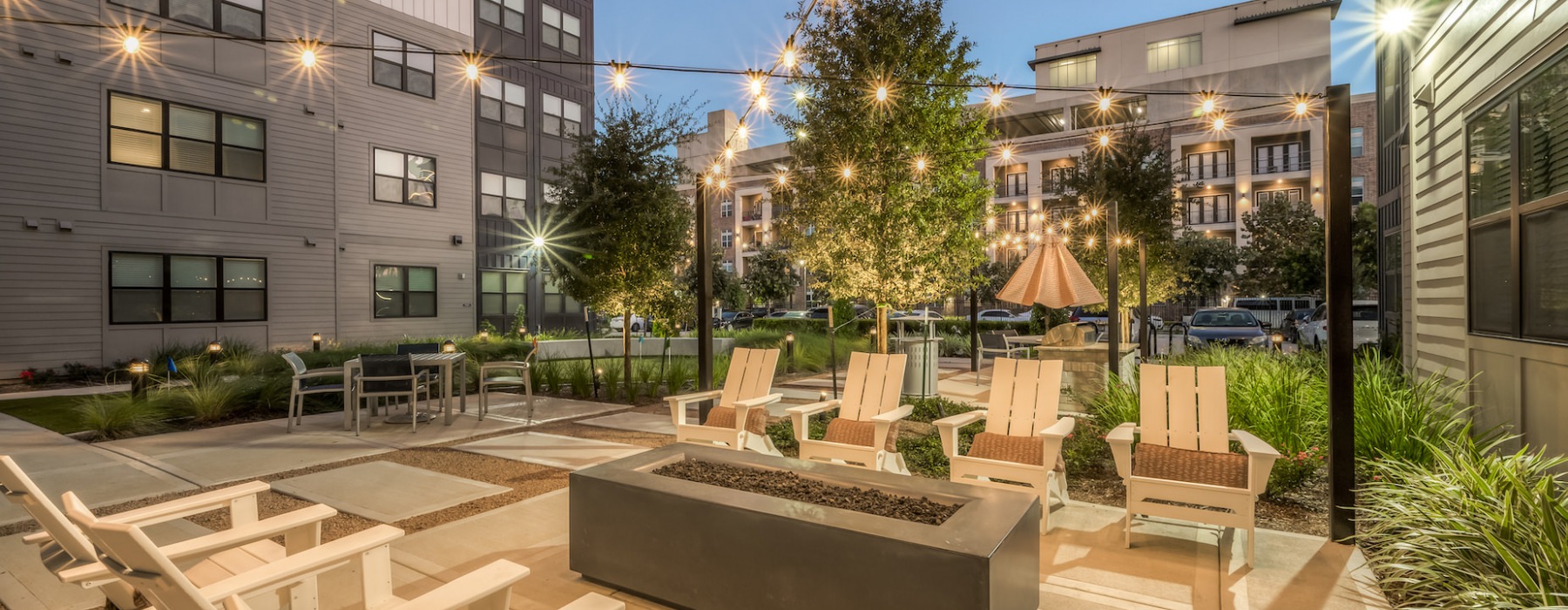 night time view of the apartment community firepit and courtyard
